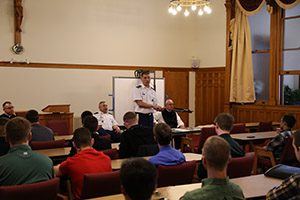 U.S. Army Chaplain Father Jason Hesseling talks with retreatants.