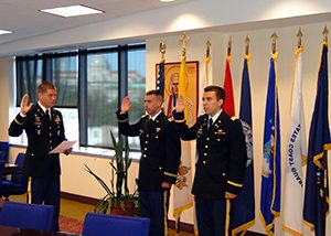 Father Jason Hesseling (left) swears in William Morrison (center) and Mark Dwyer (right) as U.S. Army Chaplain Candidates on Monday, August 3, 2015, in Washington, D.C.