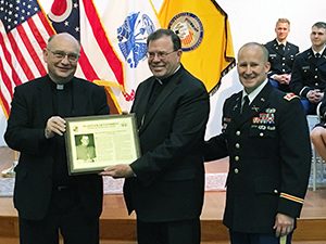 (L-R) Father Robert J. Niehoff, S.J., Bishop Neal J. Buckon, and Lt. Col. Matthew Johnson during the induction of Bishop Buckon into the Wolfpack Hall of Fame at John Carroll University, May 21, 2016.