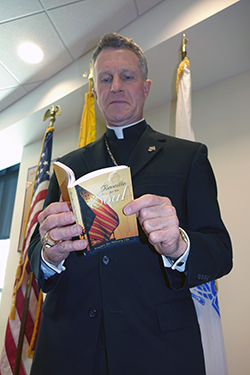 Military Services Archbishop Timothy P. Broglio peruses one of 700 copies of Liguori’s Reveille for the Soul, donated by Liguori Publications to serve the pastoral needs of recruits.