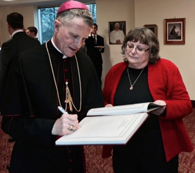 Ms. Anne Butta (right) with Archbishop Timothy P. Broglio.