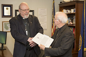  Father Norman R. Oswald (left), recipient of the Medal of the Archdiocese for the Military Services, USA (AMS), with Auxiliary Bishop Richard B. Higgins, Monday, April 20, 2015, at the Clement J. Zablocki VA Medical Center in Milwaukee, Wis. Photo courtesy of Benjamin Slane, Zablocki VA Medical Center Public Affairs.