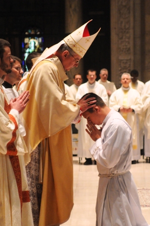 Archbishop John Nienstedt ordains Paul Shovelain a transitional deacon at the Basilica of St. Mary in Minneapolis on May 4, 2013.