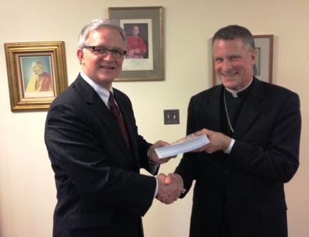 American Bible Society President and CEO Dr. S. Douglas Birdsall presents Archbishop Timothy P. Broglio the new Catholic Military Bible on April 22, 2013 in Washington, D.C. 